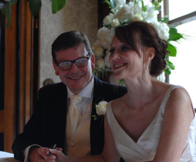 Paula and Mike signing the register at Luton Hoo